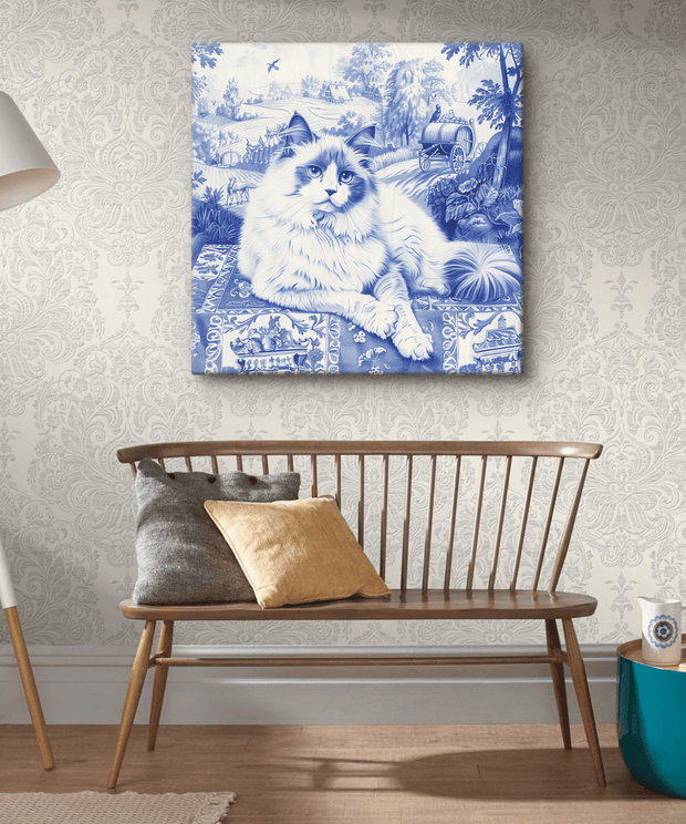 Canvas art featuring a fluffy ragdoll cat illustrated in a classic blue toile de Jouy style. The cat lounges against a scenic countryside backdrop with trees, cottages, and a vintage carriage, creating a timeless, elegant design perfect for cat and art lovers alike.