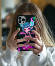 A cute pastel goth phone case featuring a chibi demon girl with teal hair, glittery pink wings, purple eyes, and glowing neon stars and hearts on a dark background.