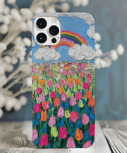 Phone case featuring a textured oil painting design of a vibrant tulip field under a blue sky with fluffy white clouds and a rainbow. The colorful brushstroke pattern in pink, orange, and green creates a cheerful, artistic spring aesthetic.