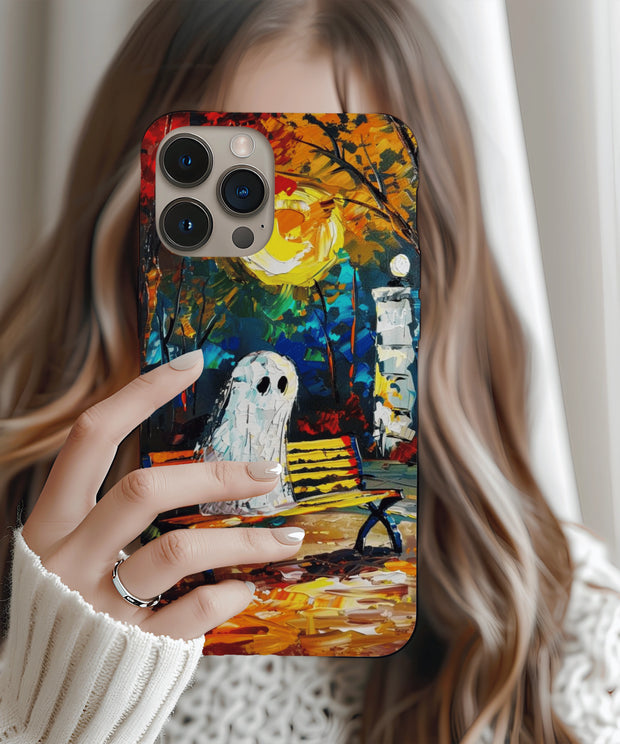 A moody autumn phone case showing a ghost sitting alone on a park bench beneath a glowing moon and colorful fall trees. The painterly brushstroke texture creates a dreamy, melancholy atmosphere.