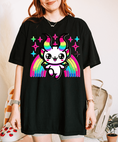 Black oversized t-shirt featuring a cute kawaii Baphomet character with rainbow horns, sparkling stars, and vibrant rainbow wings. Adorable pastel goth design blending cute and chaotic energy for a bold, colorful look.