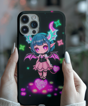 A cute pastel goth phone case featuring a chibi demon girl with teal hair, glittery pink wings, purple eyes, and glowing neon stars and hearts on a dark background.