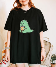 A cute green t-shirt featuring an adorable cartoon dinosaur happily sipping boba tea, creating a fun and cozy aesthetic perfect for casual or kawaii style lovers.