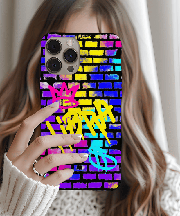 A vibrant phone case featuring the word “Libra” spray-painted in yellow graffiti over a colorful brick wall background, with pink and blue crown and zodiac symbols for a bold street art look.