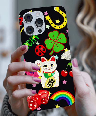 A black phone case decorated with vibrant lucky symbols including a maneki-neko cat, four-leaf clover, horseshoe, rainbow, cherries, dice, stars, and ladybug. The bold design pops with color and good fortune vibes.