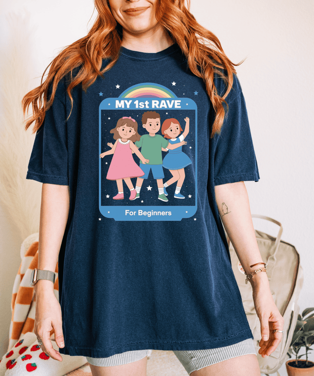 My 1st Rave Shirt – Funny Retro Cartoon Rave Graphic Tee stars around them. The design reads “MY 1st RAVE – For Beginners,” creating a playful, nostalgic, and ironic party vibe.