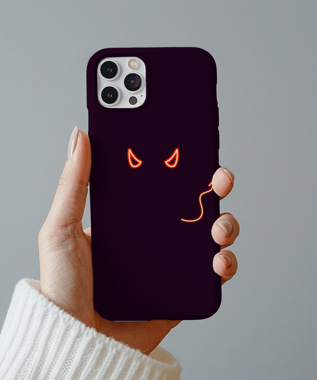 Black phone case featuring glowing red neon devil eyes and a curved tail design, creating a sleek and mischievous aesthetic. The minimal glowing art gives off a dark, bold, and edgy vibe perfect for alternative fashion lovers.