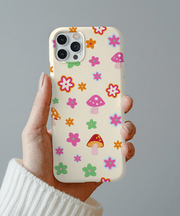 Beige phone case featuring a playful retro pattern of pink mushrooms and colorful flowers in orange, green, blue, and red. Soft pastel design with 70s-inspired charm, perfect for cottagecore lovers and fans of cute, whimsical aesthetics.
