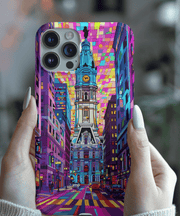 Bold and colorful phone case featuring Philadelphia’s City Hall in a neon geometric art style. The vivid design uses bright shades of pink, purple, blue, and yellow to create a modern urban aesthetic perfect for city lovers and travel-inspired tech accessories.