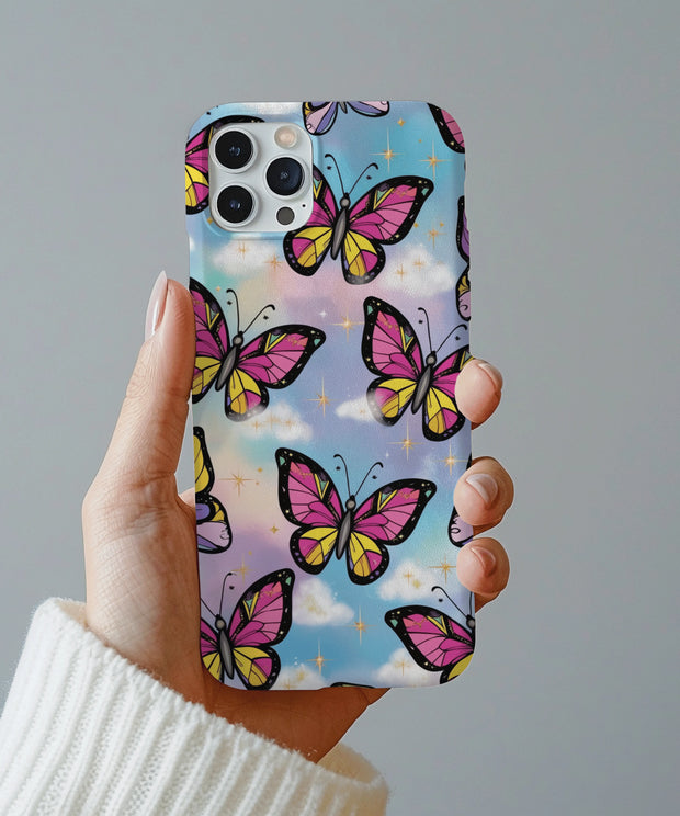 A dreamy phone case featuring pink and yellow butterflies with black outlines flying across a pastel sky background with fluffy clouds and sparkling gold stars.