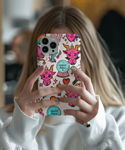 Colorful phone case featuring doodles of pink horned creatures, rainbow hearts, crystals, and crystal balls labeled “Queer Magic.” The whimsical witchy art on a grid background mixes pride, fantasy, and cute gothic charm - perfect for LGBTQ+ and magical aesthetic lovers.