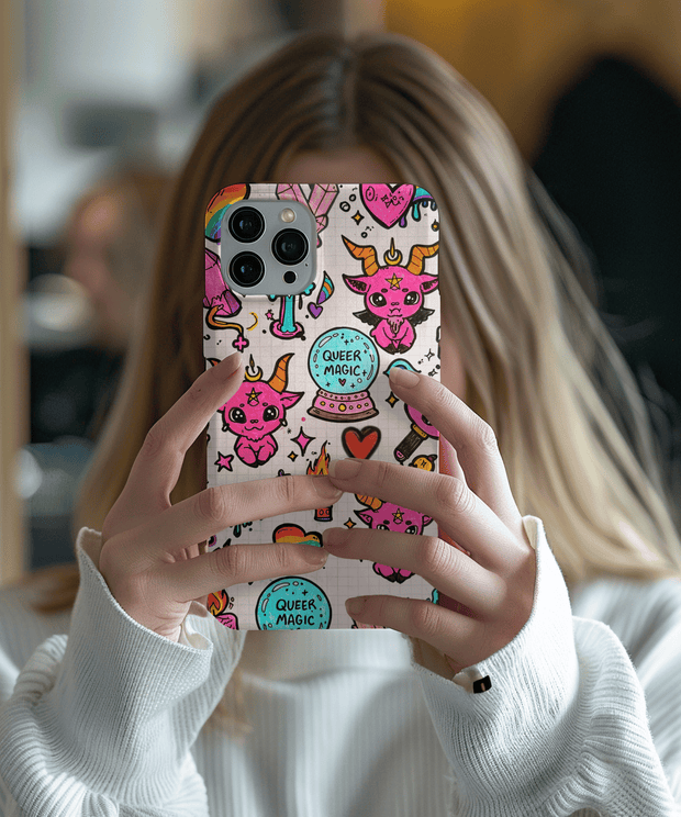 Colorful phone case featuring doodles of pink horned creatures, rainbow hearts, crystals, and crystal balls labeled “Queer Magic.” The whimsical witchy art on a grid background mixes pride, fantasy, and cute gothic charm - perfect for LGBTQ+ and magical aesthetic lovers.