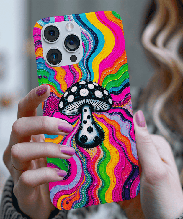 Vibrant psychedelic phone case featuring a black and white spotted mushroom centered on a swirling rainbow background with neon pink, yellow, green, and blue waves. A bold trippy design perfect for boho, festival, and retro art lovers.