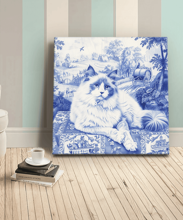 Canvas art featuring a fluffy ragdoll cat illustrated in a classic blue toile de Jouy style. The cat lounges against a scenic countryside backdrop with trees, cottages, and a vintage carriage, creating a timeless, elegant design perfect for cat and art lovers alike.
