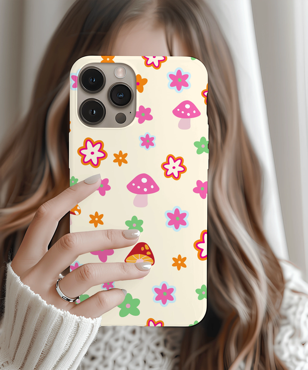 Beige phone case featuring a playful retro pattern of pink mushrooms and colorful flowers in orange, green, blue, and red. Soft pastel design with 70s-inspired charm, perfect for cottagecore lovers and fans of cute, whimsical aesthetics.