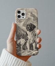 Beige and black phone case featuring a detailed vintage-style illustration of a Saint Bernard standing proudly against a snowy mountain landscape. Classic alpine dog design with rustic charm, perfect for nature and dog lovers.