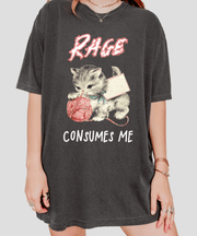 Gray oversized t-shirt featuring a vintage-style kitten tangled in pink yarn with the bold phrase “Rage Consumes Me.” A funny, ironic design blending cute and chaotic energy—perfect for cat lovers with a sarcastic sense of humor.