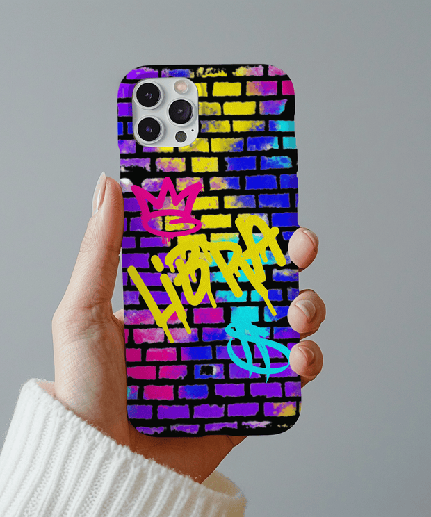 A vibrant phone case featuring the word “Libra” spray-painted in yellow graffiti over a colorful brick wall background, with pink and blue crown and zodiac symbols for a bold street art look.