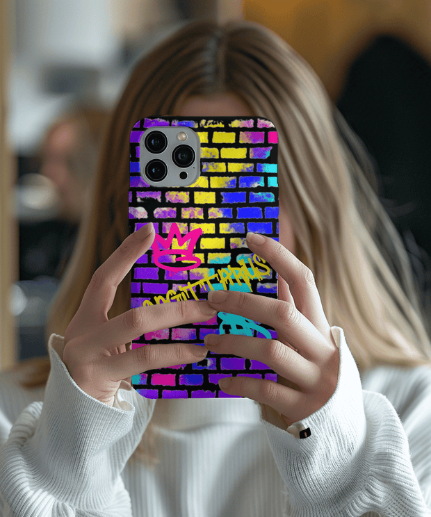 Colorful Sagittarius phone case featuring neon graffiti lettering on a vibrant brick wall background with pink, yellow, blue, and purple spray paint textures. Includes graffiti-style zodiac symbols, perfect for astrology fans who love bold urban streetwear vibes.