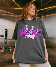 Gray oversized t-shirt with the word “Pisces” in a purple graffiti-style drip font and ink-splatter accents. The design gives off a bold, artsy zodiac vibe perfect for astrology lovers and those with a creative, dreamy edge.